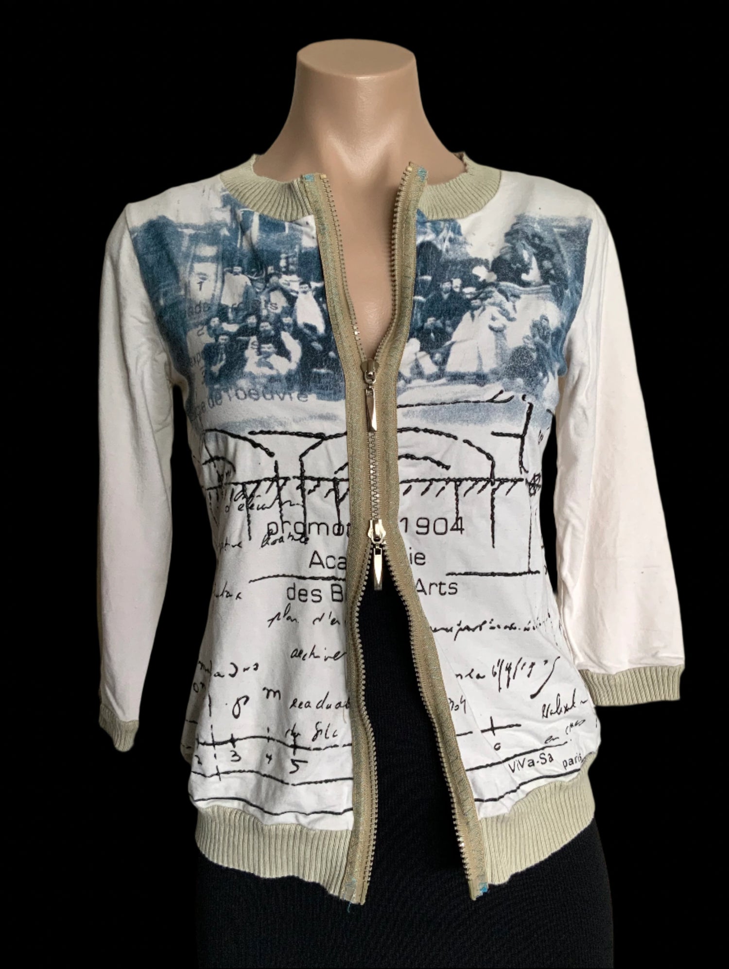 Mannequin wearing a white jacket with artistic design on a plain background