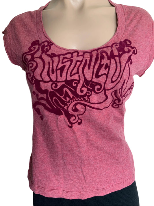 Pink t-shirt with black intricate design on a mannequin against a white background